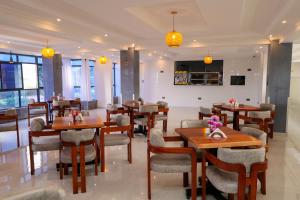 a restaurant with tables and chairs in a room at Maraluxe Resoert & Spa in Nakuru