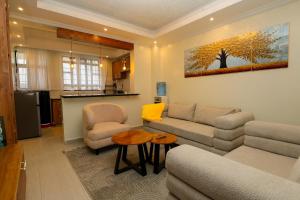 a living room with a couch and chairs and a table at Maraluxe Resoert & Spa in Nakuru