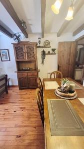a dining room with a wooden table and chairs at Apartamentos Nogueret in Benasque
