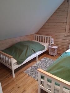 a bedroom with two bunk beds in a attic at Blockbohlenhaus-Steiner-Lodge in Steinen