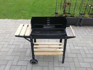 a barbecue grill with a bench on a patio at Blockbohlenhaus-Steiner-Lodge in Steinen