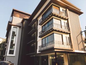 a building with balconies on the side of it at TUCK Me iN in Chiang Mai