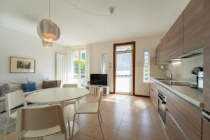 a kitchen and living room with a table and chairs at Bellagio Breva in Bellagio