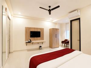 a hotel room with a bed and a tv at Hotel 33 Inn in Kānpur