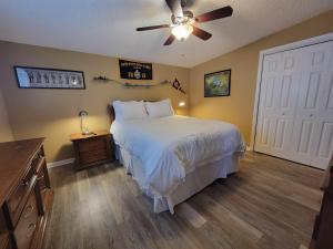 a bedroom with a bed and a ceiling fan at Blue Gem in Key West +63 photos