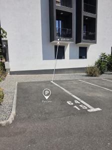 a parking lot in front of a building at Sakura Residence Felix in Sînmartin +8 photos