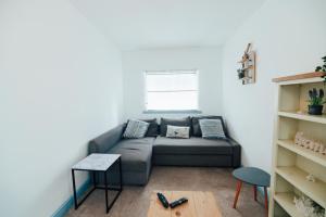 a living room with a couch and a table at The Graigfryn Hideaway in Amlwch +5 photos