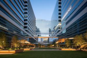 a large building with tall buildings in a city at YOTEL Bangkok Sukhumvit in Ban Nong Chaeng