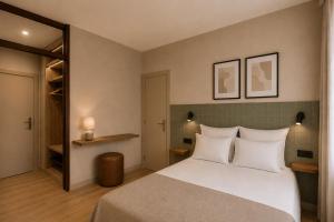 a bedroom with a large bed with white pillows at Colectia Hotel Santa Lucía in Seville