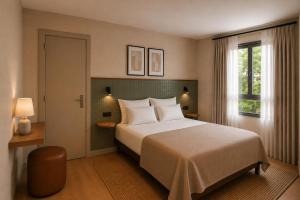 a bedroom with a large bed and a window at Colectia Hotel Santa Lucía in Seville