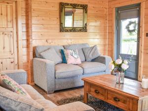 a living room with a couch and a coffee table at Pine Lodge - Uk30007 in Lindal in Furness
