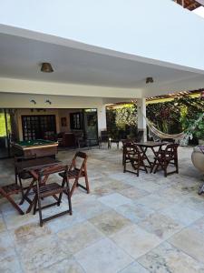 a patio with ping pong tables and a hammock at Ventos e Dunas Cumbuco in Cumbuco