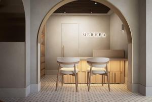 a dressing room with two tables and two stools at Casa Azure Meliá Collection in San Lawrenz