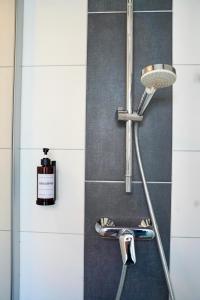 a shower in a bathroom with a bottle of soap at PrimeBnb Bad Hersfeld in Bad Hersfeld