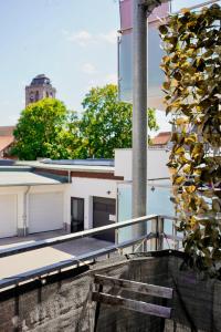 a balcony with a bench and a building at PrimeBnb Bad Hersfeld in Bad Hersfeld