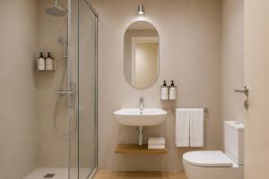 a bathroom with a sink and a toilet and a shower at Colectia Hotel Santa Lucía in Seville