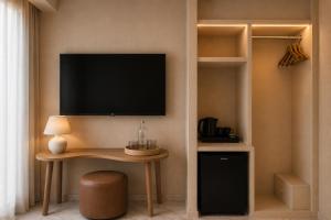 a room with a table and a television on a wall at Colectia Hotel Santa Lucía in Seville +18 photos