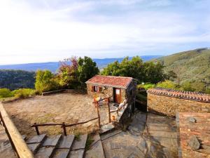 a small house on top of a hill at Refúgio do Casal in Lousã +5 photos