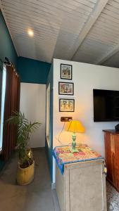 a room with a table with a lamp on it at MATANAI HOUSE X THHP - The Deck Villa Mukteshwar - 2 Bedroom Bonfire & BBQ in Mukteshwar +45 photos