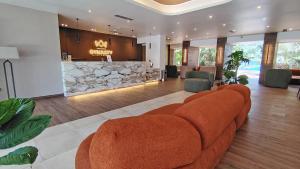 a living room with a couch and a fireplace at Hotel Margarita Dynasty in Porlamar
