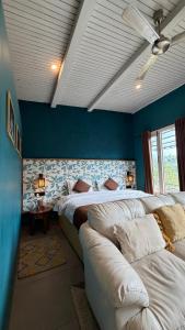 a bedroom with two beds and a ceiling fan at MATANAI HOUSE X THHP - The Deck Villa Mukteshwar - 2 Bedroom Bonfire & BBQ in Mukteshwar