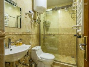 a bathroom with a toilet and a sink and a shower at Hotel Iveria in Abastumani +50 photos