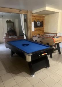 a ping pong table in a room with a pool table at Gîte proche de La Salvetat in Le Soulié
