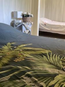 a bedroom with a bed with a colorful blanket on it at Gîte proche de La Salvetat in Le Soulié