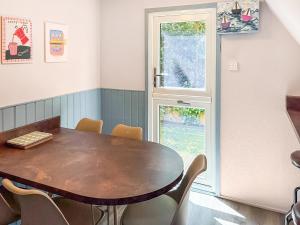 a dining room with a wooden table and chairs at Lodge 64 in Kingsdown