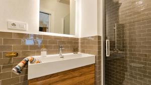 a bathroom with a white sink and a mirror at Villa Costa Cue in Cue +35 photos
