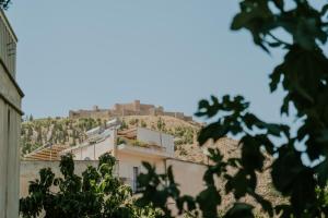 a building on top of a hill with trees at Chez Jean in Argos