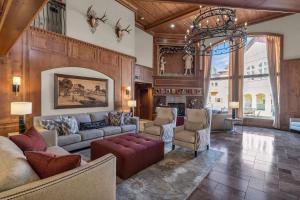 a living room with a couch and chairs and a chandelier at Zermatt Mountain Lodge Studio in Midway
