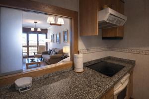 a kitchen with a sink and a living room at Apto Marita – Nueva de Llanes cerca de la Playa in Nueva de Llanes +15 photos