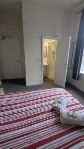 a bedroom with a large bed with two open doors at Bristol Hotel in Bristol +16 photos