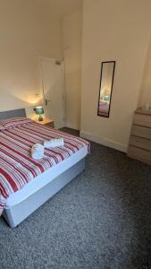 a bedroom with a bed with two towels on it at Bristol Hotel in Bristol
