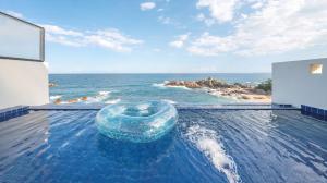 a swimming pool with a view of the ocean at yeongdeok chaeumneul poolvilla in Yŏngdŏk +3 photos