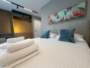 a bedroom with two beds with blue and white pillows at SD House in Vlorë