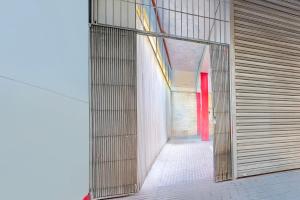 a hallway with a red door in a building at Super Hotel O Dighori Nagpur in Sakardarā