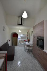a kitchen and living room with a couch and a table at Gran Paradiso Guest House in Tivoli
