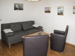 a living room with a couch and a table at Holiday Home Goetheallee by Interhome in Krakow am See