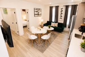 a living room with a table and chairs and a couch at Mary's Stay H St Corridor in Washington, D.C.