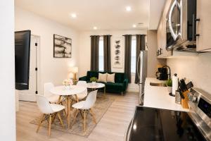 a kitchen and living room with a table and chairs at Mary's Stay H St Corridor in Washington, D.C.