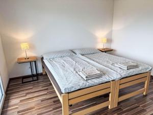a bed in a room with two lamps on two tables at Apartment Luxenweid by Interhome in Reichenburg