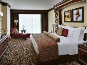 a hotel room with a large bed and a large window at Mövenpick Hotel City Star Jeddah in Jeddah