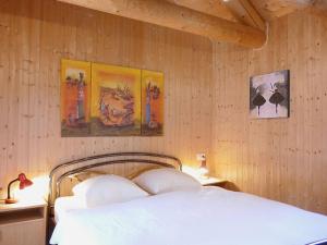 a bedroom with a bed and some pictures on the wall at Holiday Home Rustico Nurell by Interhome in Madra