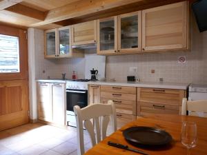 a kitchen with wooden cabinets and a table with a plate on it at Holiday Home Rustico Nurell by Interhome in Madra