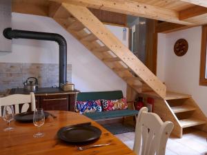 a kitchen with a wooden table and a wooden stairs at Holiday Home Rustico Nurell by Interhome in Madra +28 photos