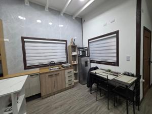an office with a desk and a large window at Casa en Lanco in Lanco