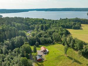 an aerial view of a house on a field with a lake at Holiday Home Teåker by Interhome in Bäckefors
