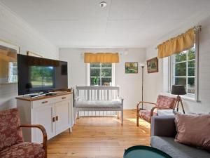 a living room with a tv and a couch at Holiday Home Teåker by Interhome in Bäckefors +33 photos